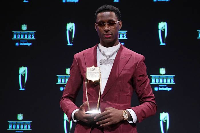 Jets' CB Sauce Gardner holds the 2022 NFL DROTY trophy